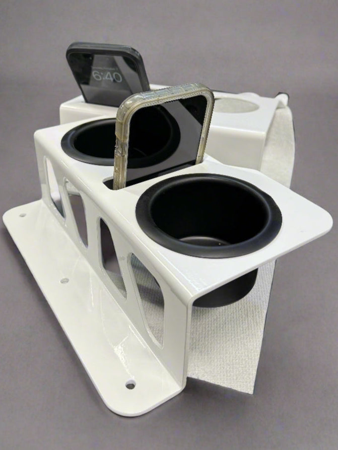 White and black speaker on a perforated metal surface with a blurred background